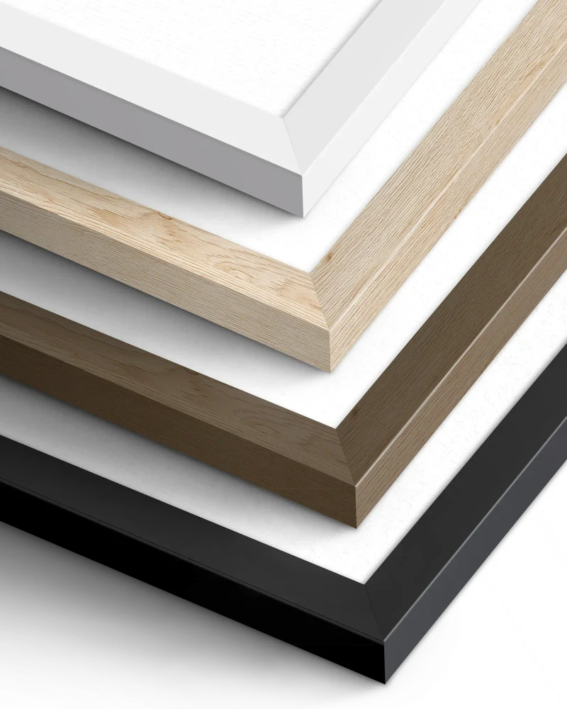 Close-up of gallery frame corners in black, white, and natural wood finishes